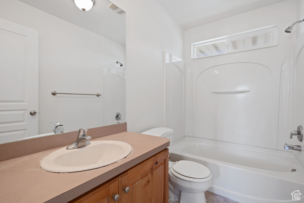 Full bathroom featuring toilet,  shower combination, and vanity