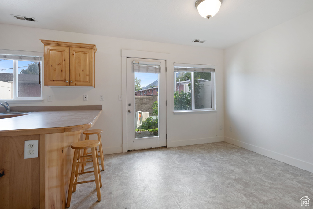 Kitchen featuring a breakfast bar and baseboards