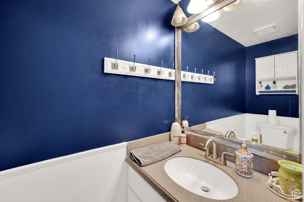 Bathroom with wainscoting and vanity