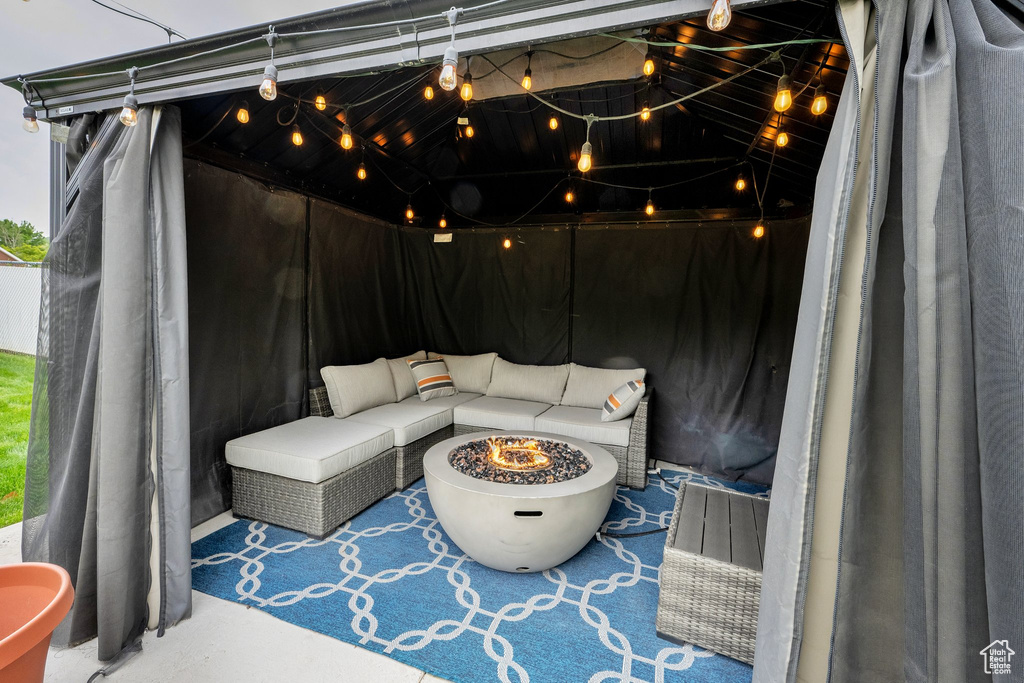 View of patio with an outdoor fire pit