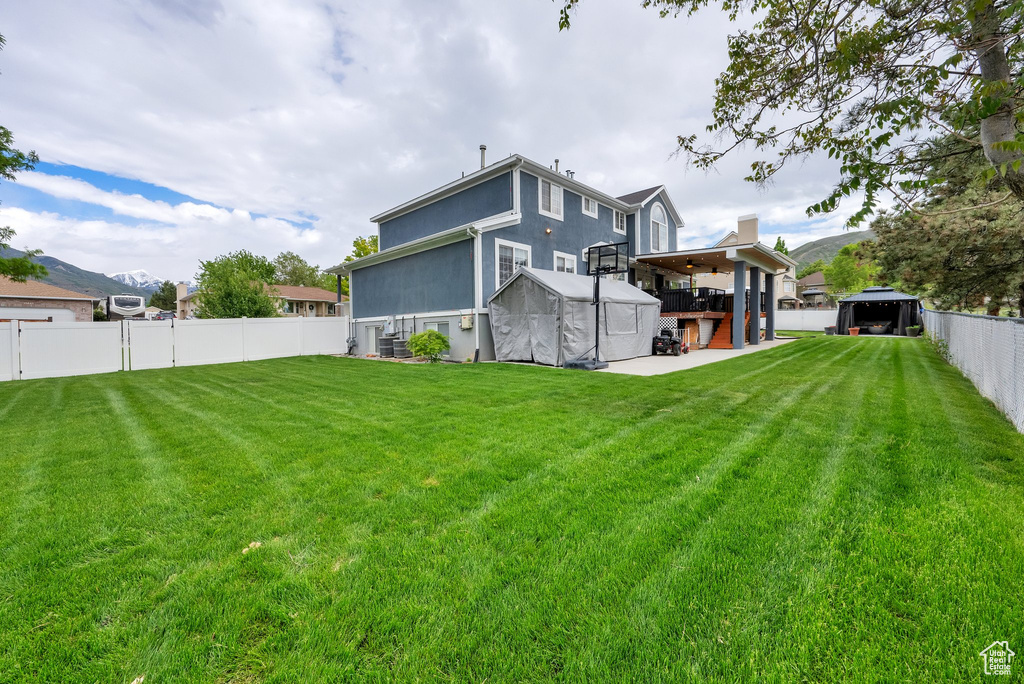 Back of property featuring a storage shed and an outbuilding