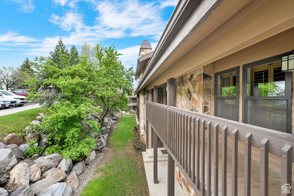 View of side of property with stone siding and a chimney