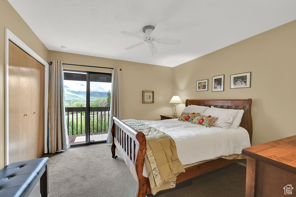 Carpeted bedroom with access to outside, a ceiling fan, and a closet