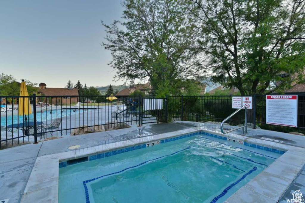 View of swimming pool featuring fence