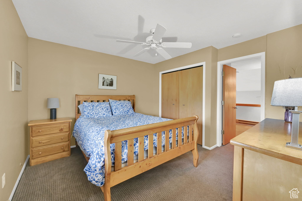 Bedroom featuring carpet flooring, a closet, baseboards, and a ceiling fan