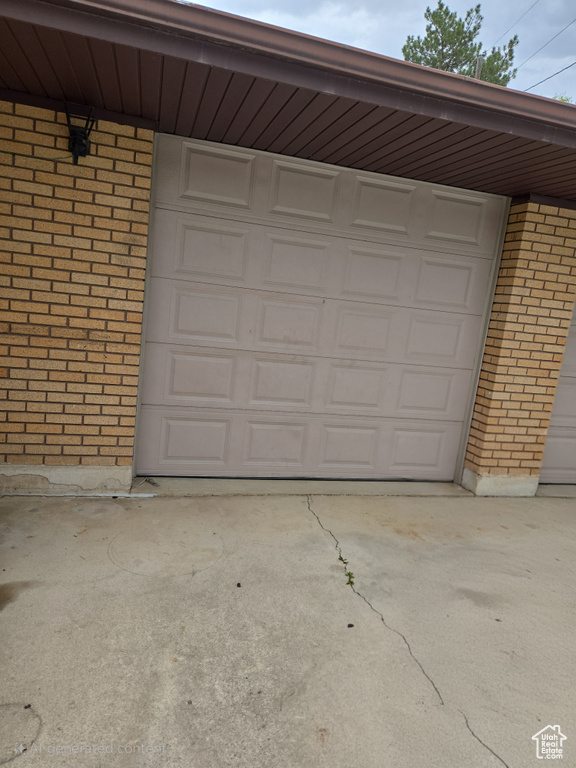 Garage featuring concrete driveway