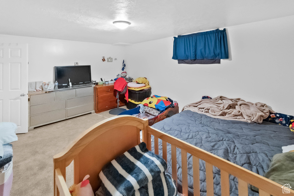 Bedroom featuring carpet floors and a textured ceiling
