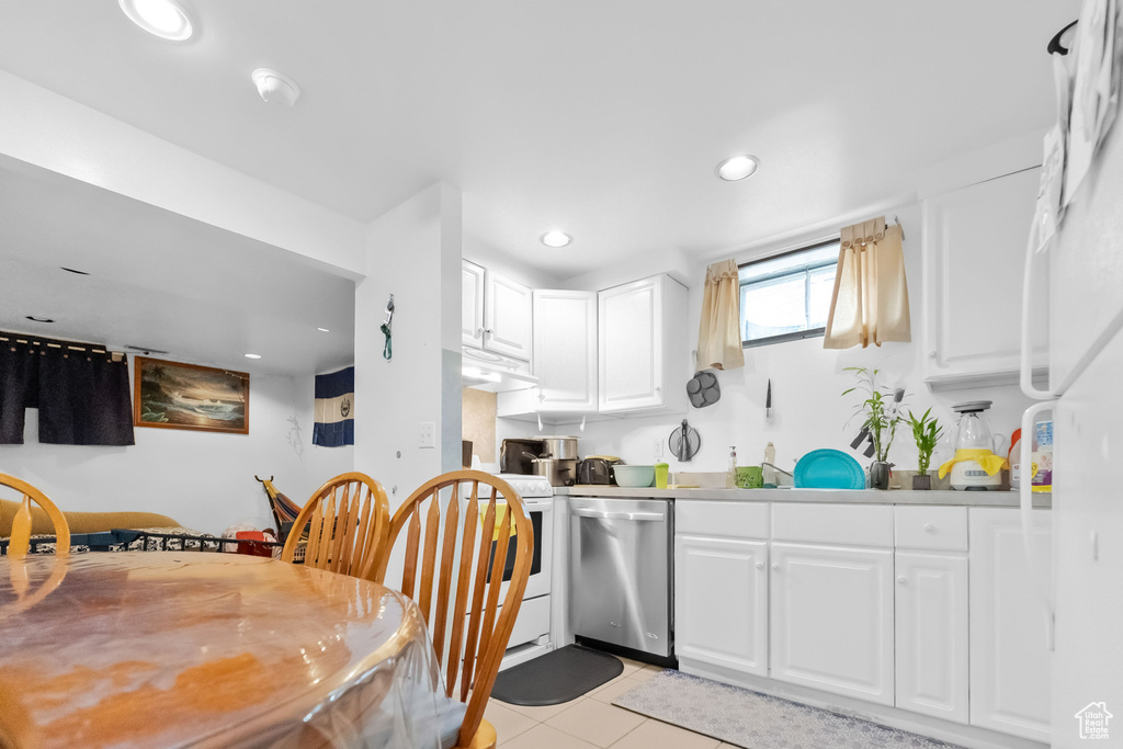 Kitchen with white range with electric cooktop, dishwasher, recessed lighting, white cabinets, and light tile patterned floors