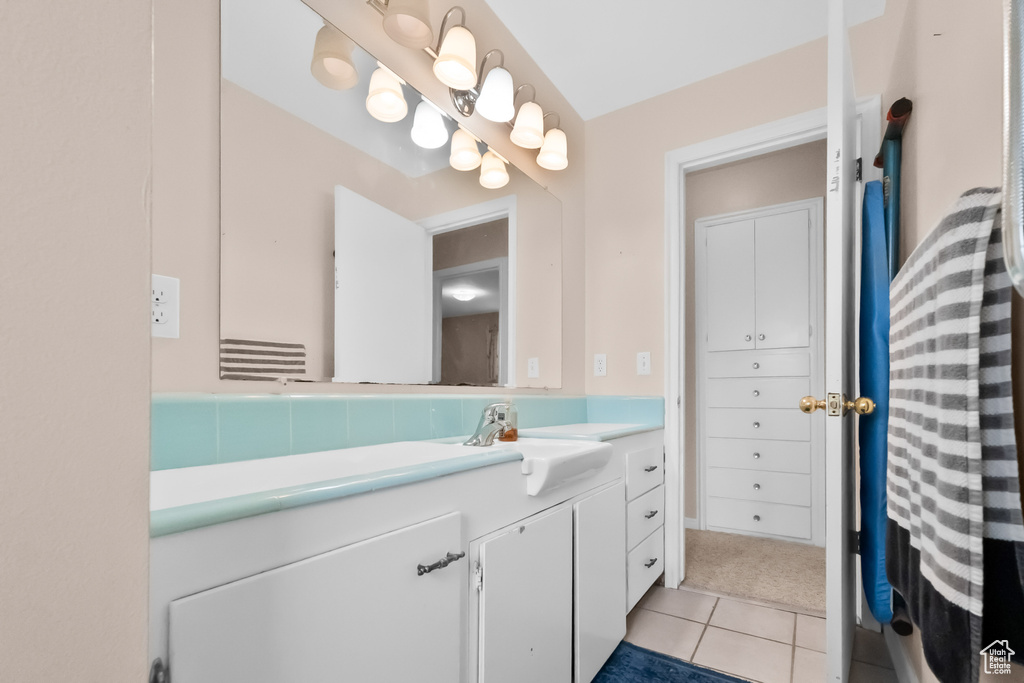 Bathroom featuring tile patterned flooring and vanity