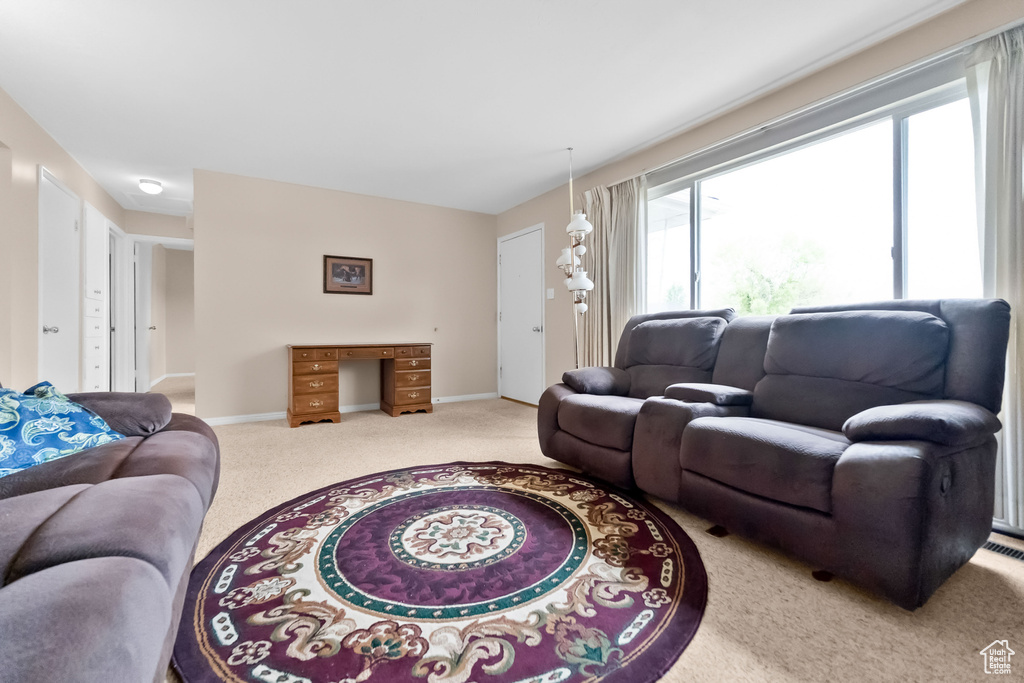 Carpeted living area with baseboards
