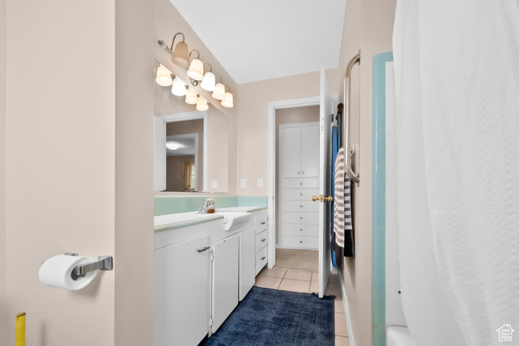Full bath with vanity and tile patterned floors