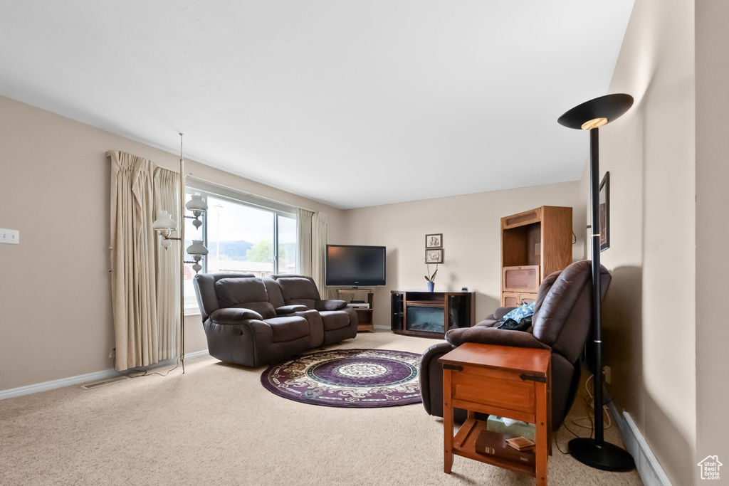 Carpeted living area with baseboards