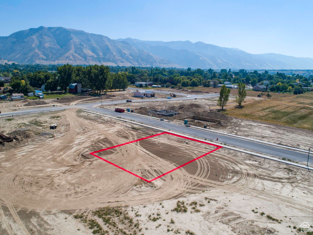Aerial view of property's location with property parcel outlined and a mountainous background