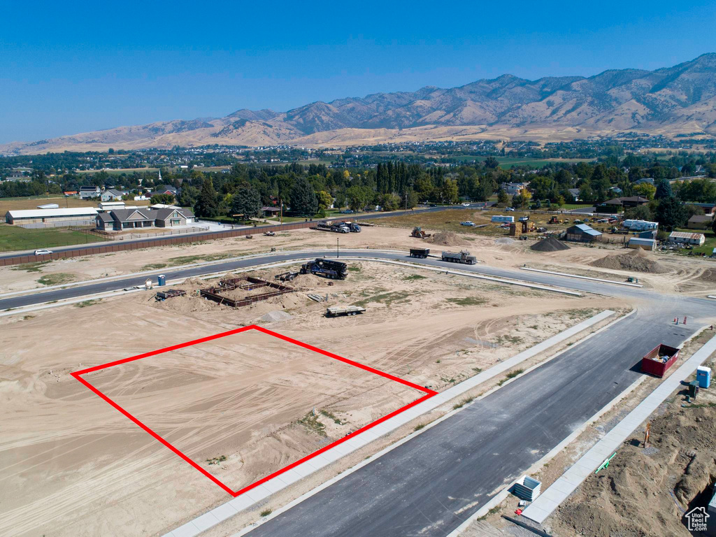Aerial view of property's location with property parcel outlined and a mountainous background