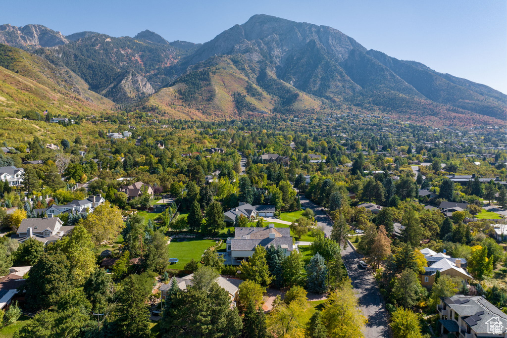 Aerial view of property's location with a mountain backdrop and nearby suburban area