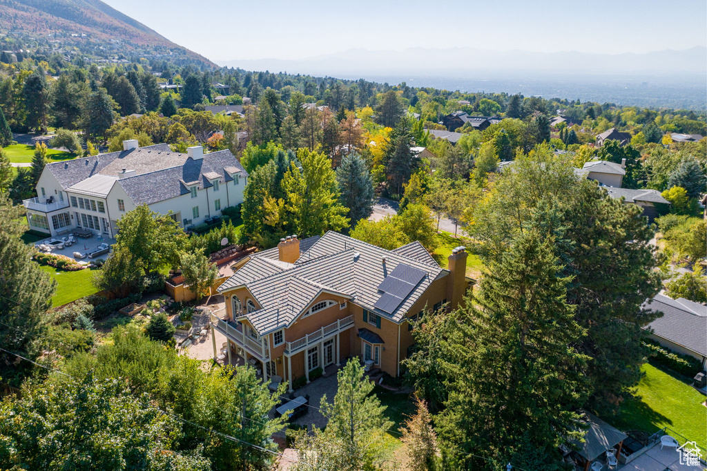 Aerial view of property and surrounding area with a mountainous background