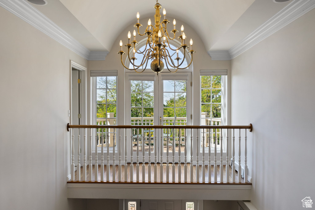 Unfurnished sunroom with french doors, a chandelier, lofted ceiling, and plenty of natural light