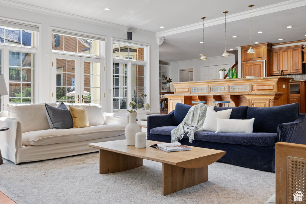 Carpeted living room with crown molding and recessed lighting