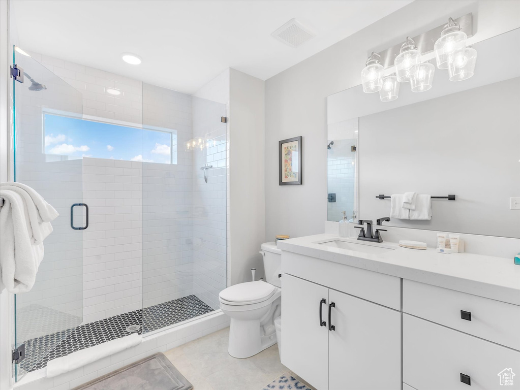 Full bath featuring toilet, a shower stall, and vanity