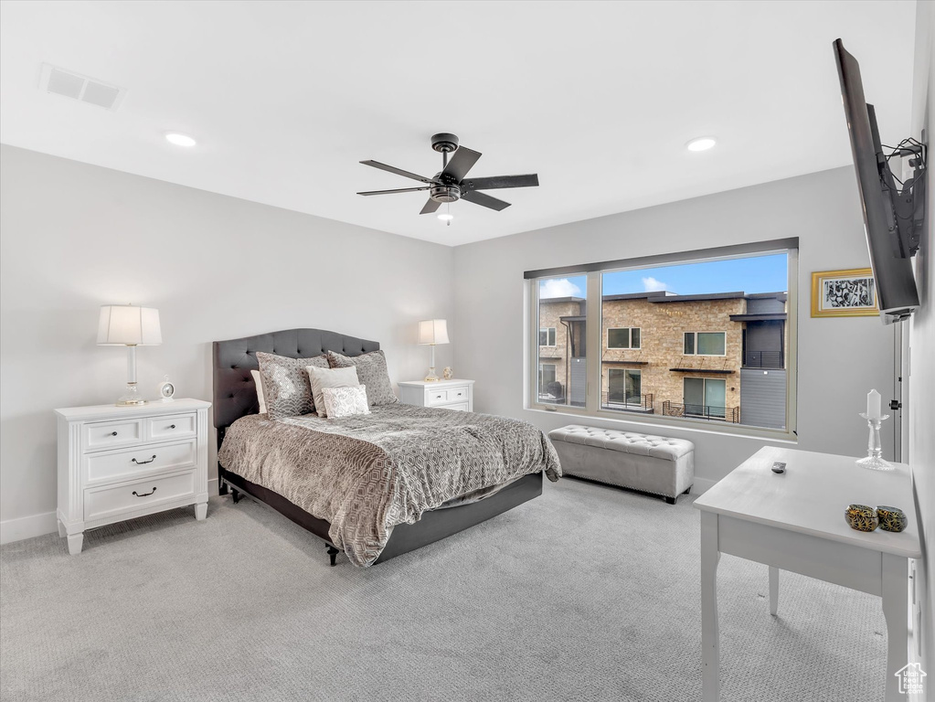 Bedroom with light colored carpet, baseboards, a ceiling fan, and recessed lighting