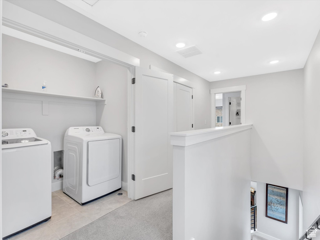 Laundry area with washer and clothes dryer, recessed lighting, and light tile patterned floors