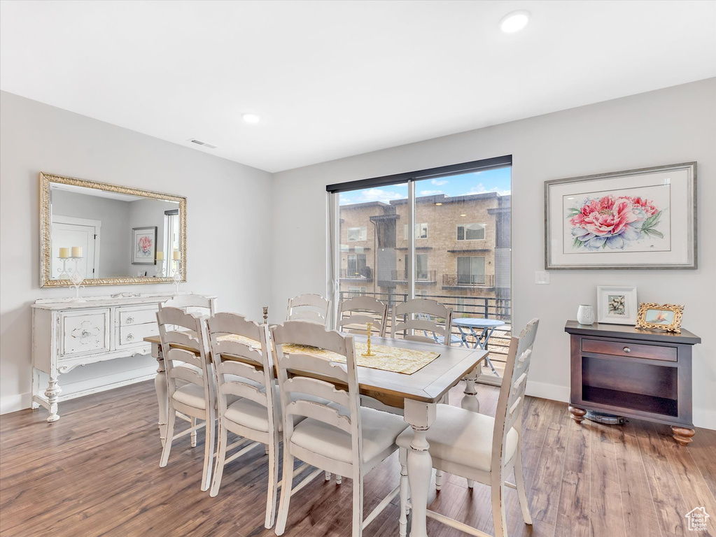 Dining area with wood finished floors, baseboards, and recessed lighting