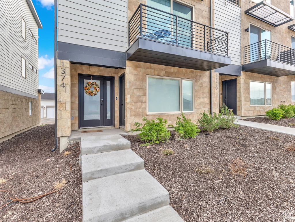 Property entrance featuring a balcony