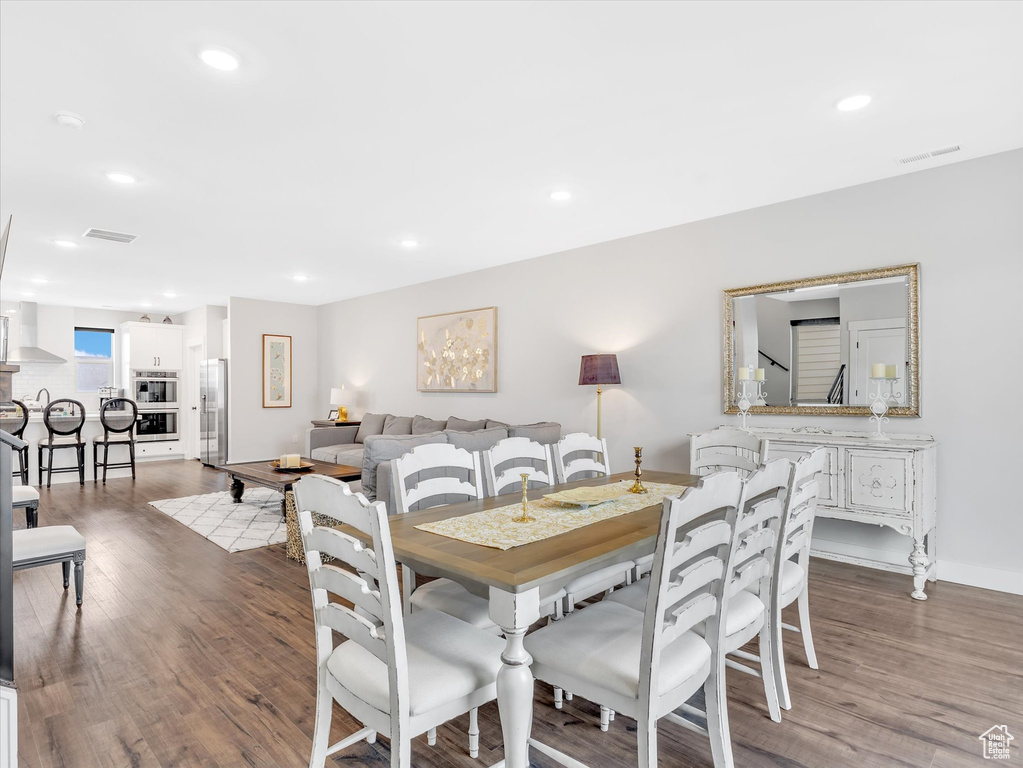 Dining space featuring wood finished floors, recessed lighting, and baseboards