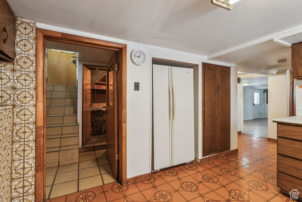Hallway with light tile patterned floors