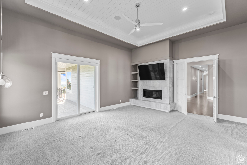 Unfurnished living room with ceiling fan, carpet flooring, baseboards, a high end fireplace, and recessed lighting