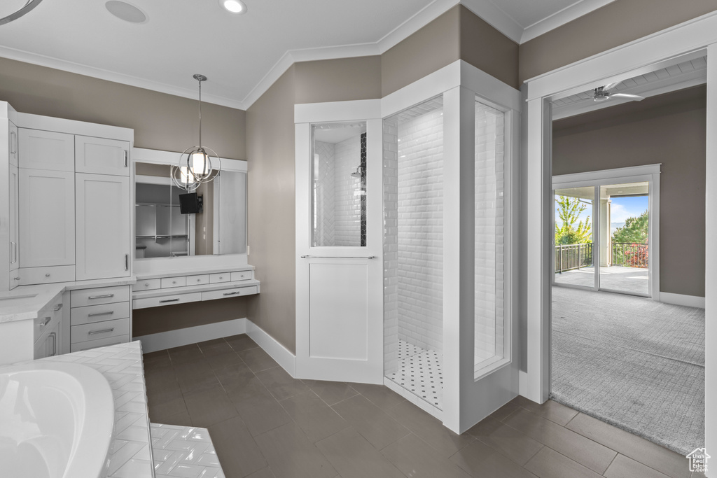Full bathroom with ornamental molding, tiled tub, baseboards, recessed lighting, and tile patterned floors
