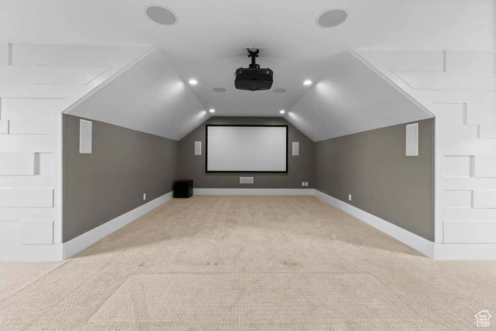 Home theater with light carpet, lofted ceiling, baseboards, and recessed lighting