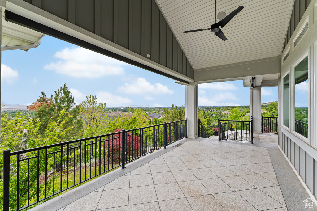 View of patio featuring a ceiling fan and a balcony