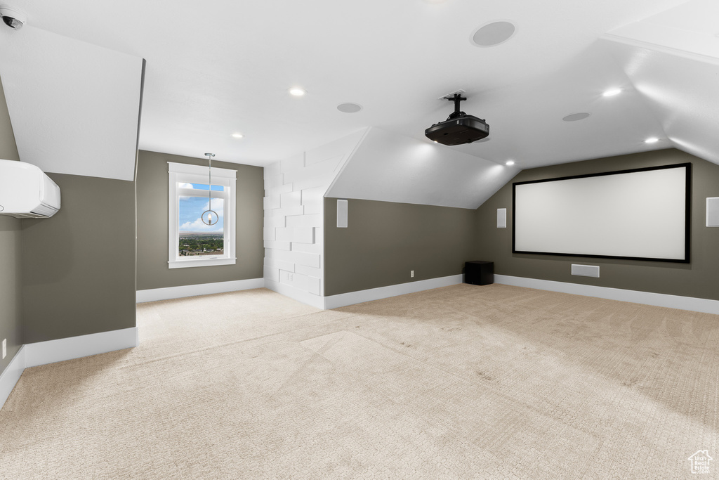Carpeted home theater with baseboards, lofted ceiling, recessed lighting, and a wall mounted AC