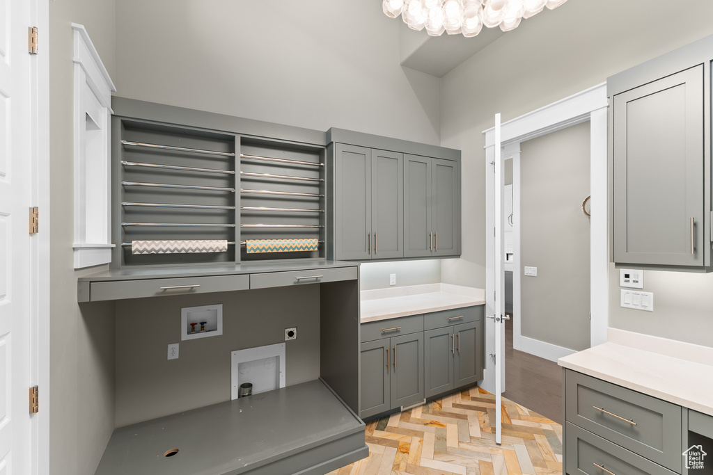 Laundry room featuring cabinet space, electric dryer hookup, washer hookup, and baseboards