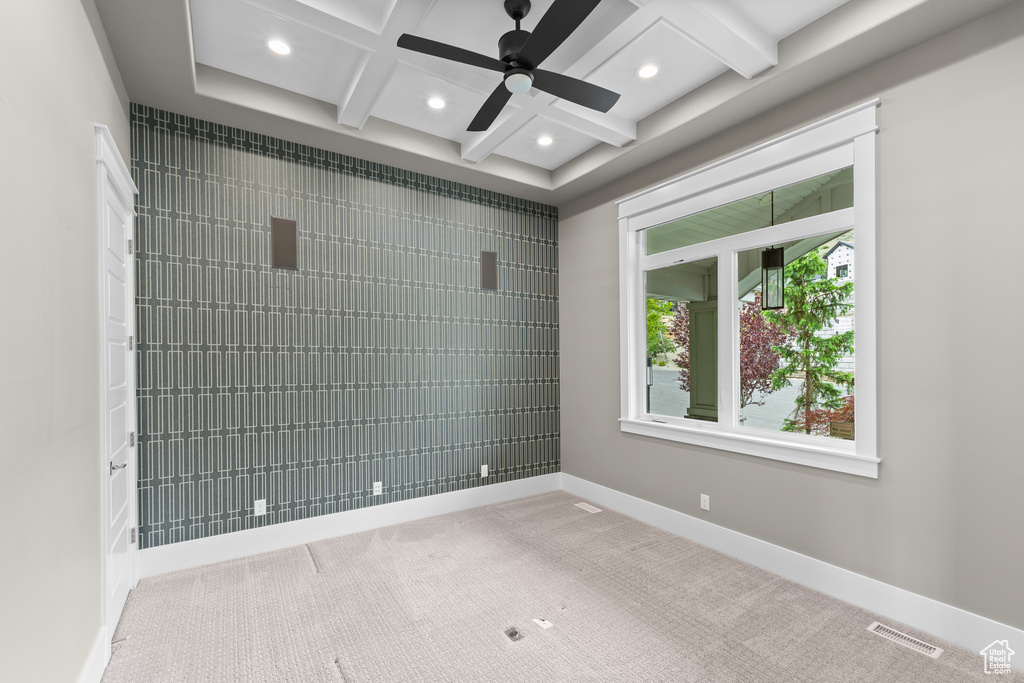 Carpeted spare room featuring coffered ceiling, ceiling fan, recessed lighting, baseboards, and beamed ceiling