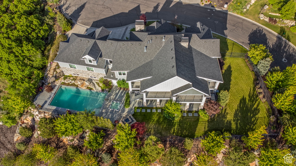 Aerial view of property and surrounding area with a pool