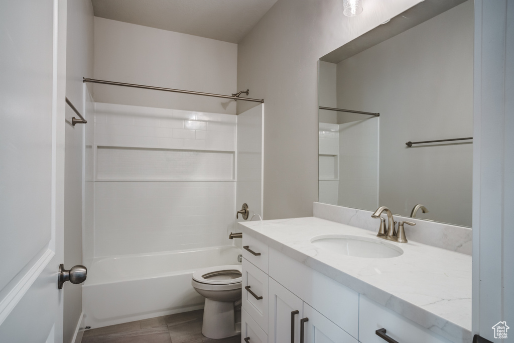 Bathroom with toilet, vanity, and shower / bathtub combination