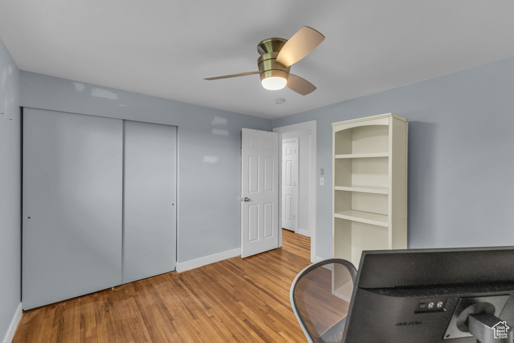 Office with wood finished floors, ceiling fan, and baseboards