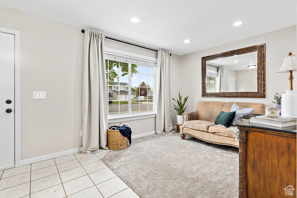 Living area with baseboards, recessed lighting, and light tile patterned flooring