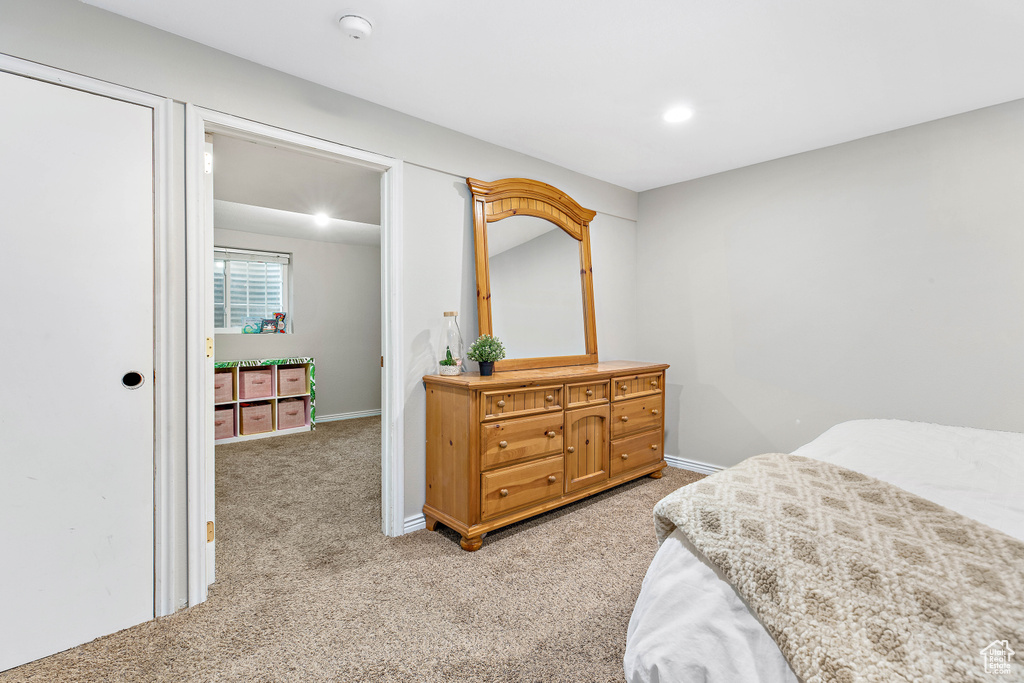 Bedroom with light colored carpet, baseboards, and recessed lighting