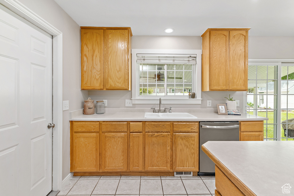 Kitchen with dishwasher, a sink, light countertops, healthy amount of natural light, and recessed lighting