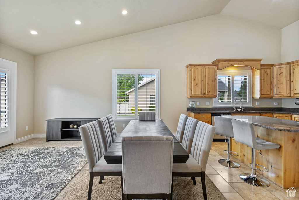 Dining room with recessed lighting and high vaulted ceiling