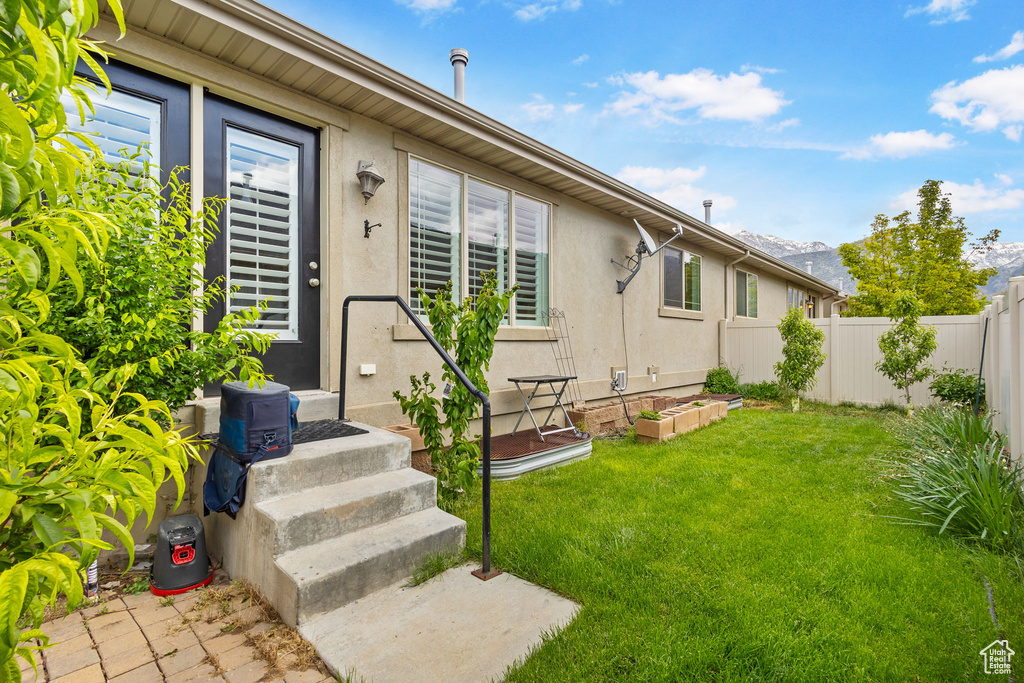 Entrance to property with stucco siding and a mountain view