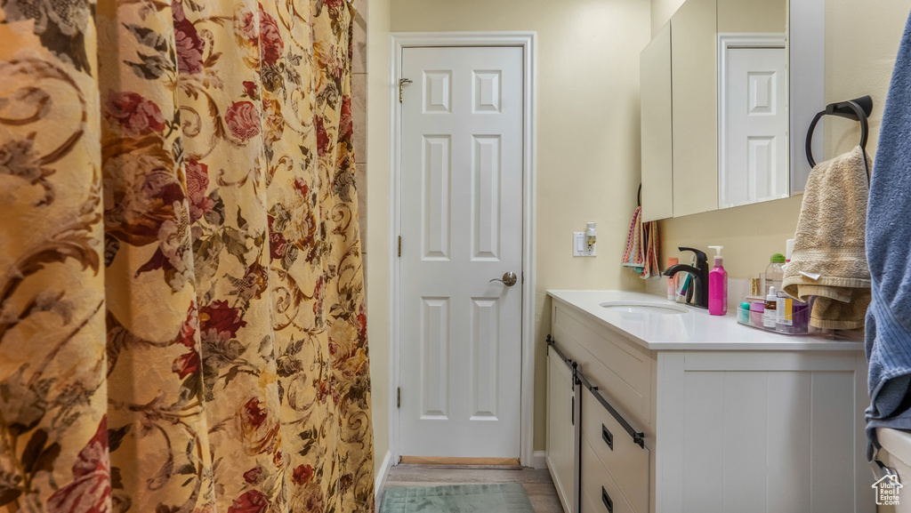 Full bathroom with vanity and curtained shower
