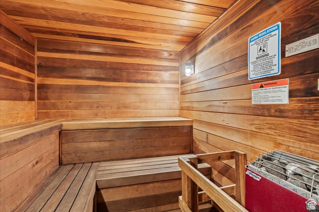 Sauna / steam room featuring wood ceiling and wooden walls