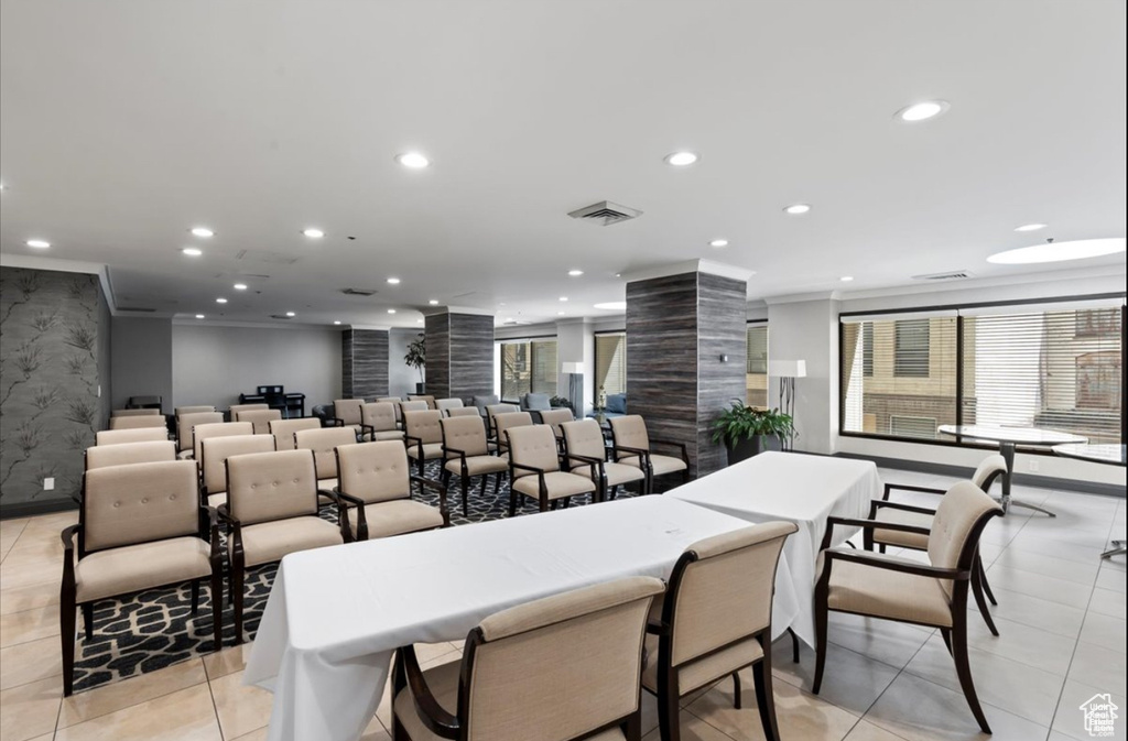 Dining room with decorative columns, recessed lighting, light tile patterned floors, crown molding, and baseboards