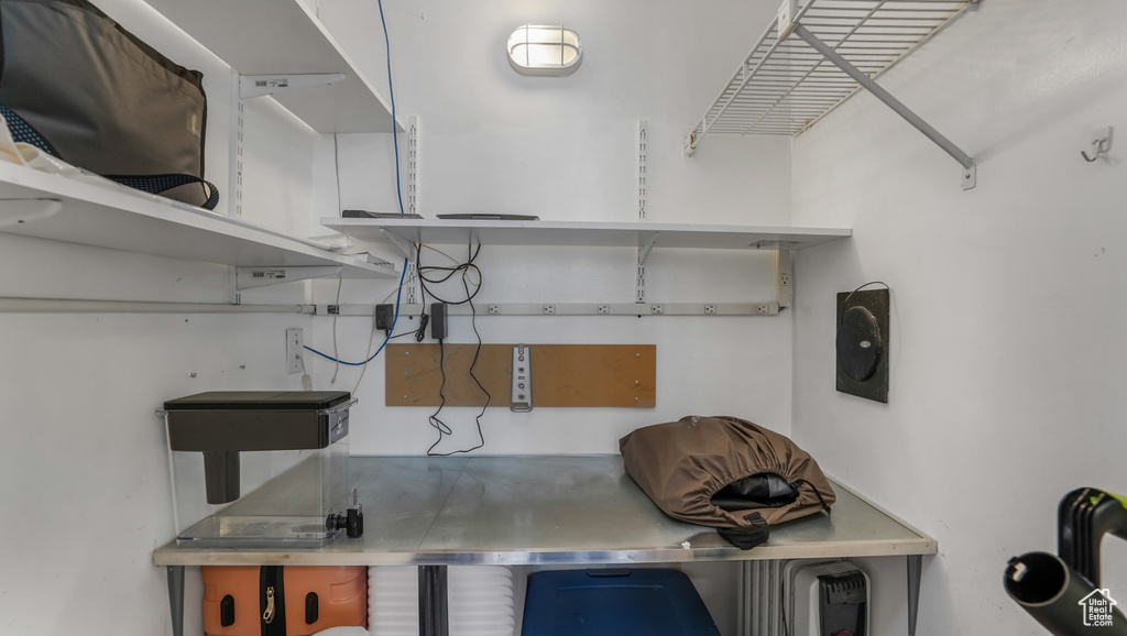 Kitchen featuring stainless steel counters and open shelves