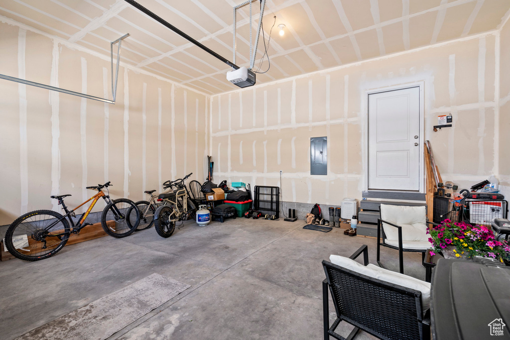 Garage with electric panel and a garage door opener
