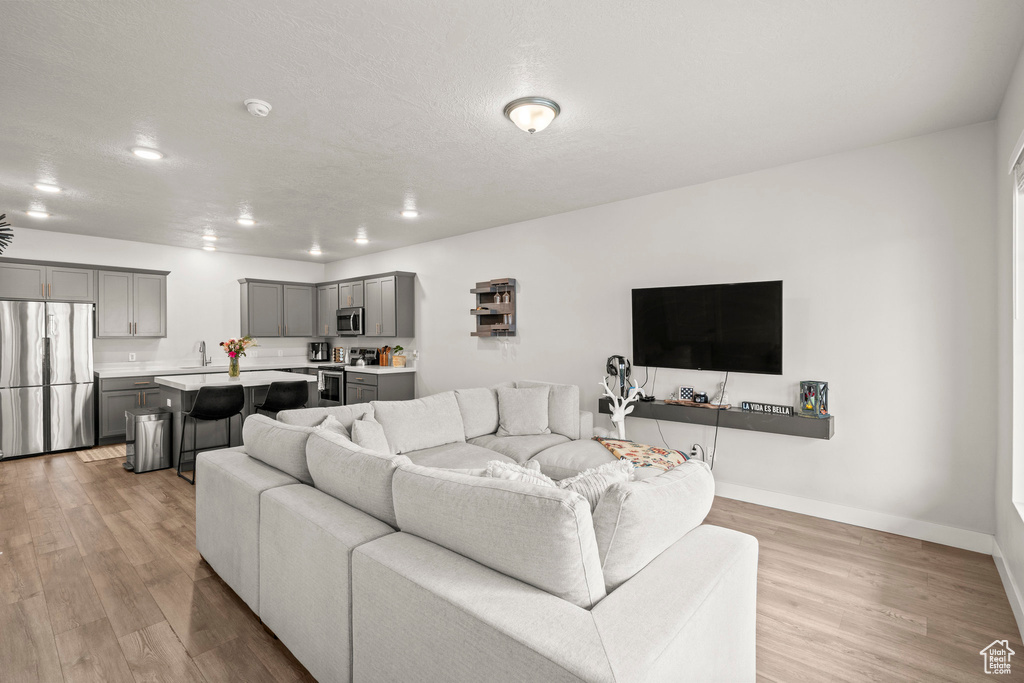 Living area with light wood-style floors and baseboards